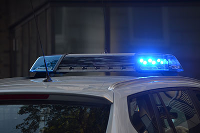 Lights on top of a police car glowing blue