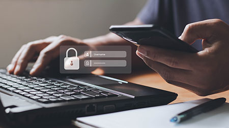 Student logging onto computer with Username and Password box in foreground